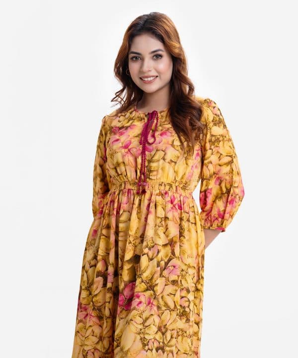 Women's long pattern flared Maxi in printed georgette fabric. Round neck with tassel ties, three-quarter sleeves. Smokey gathered waistline and patch at hem.