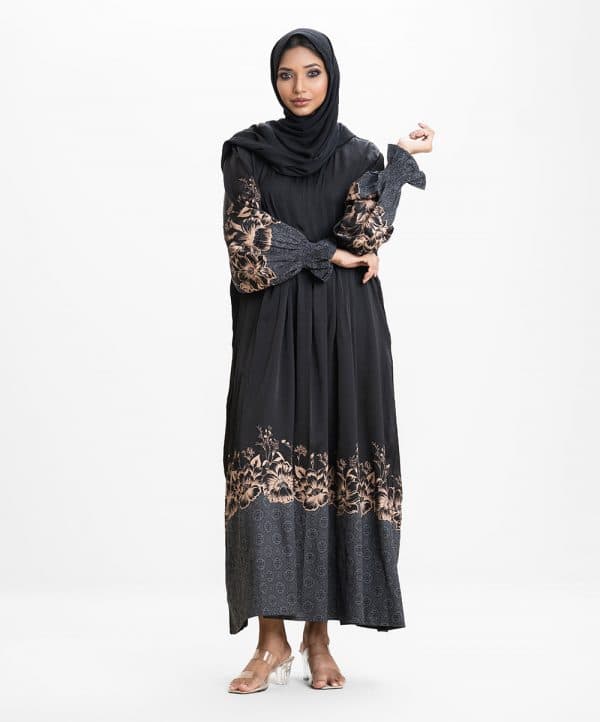 Women's gown style abaya in crepe fabric. Round neck, bishop sleeves. Box pleated waistline. Karchupi and print detail at sleeves and hemline.