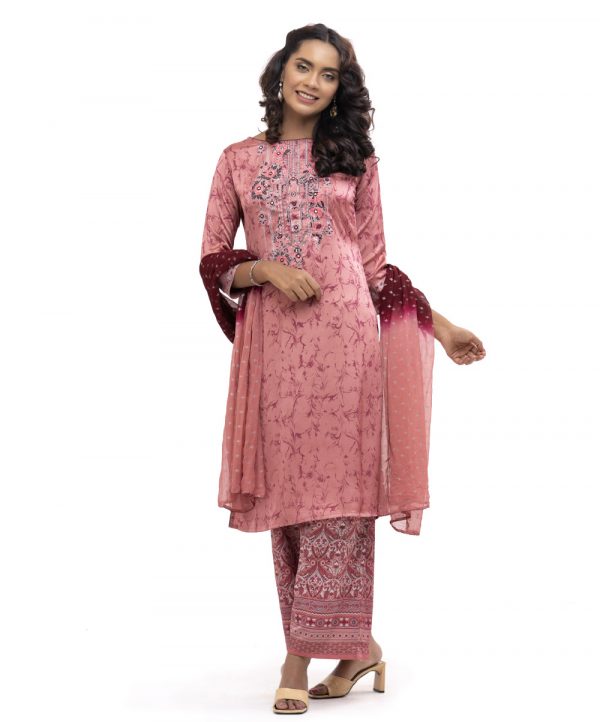 Pink all-over printed Salwar Kameez in crepe fabric. The Kameez is designed with a round neck and three-quarter sleeves. Embellished with embroidery at the front. Complemented by palazzo pants and printed chiffon dupatta.