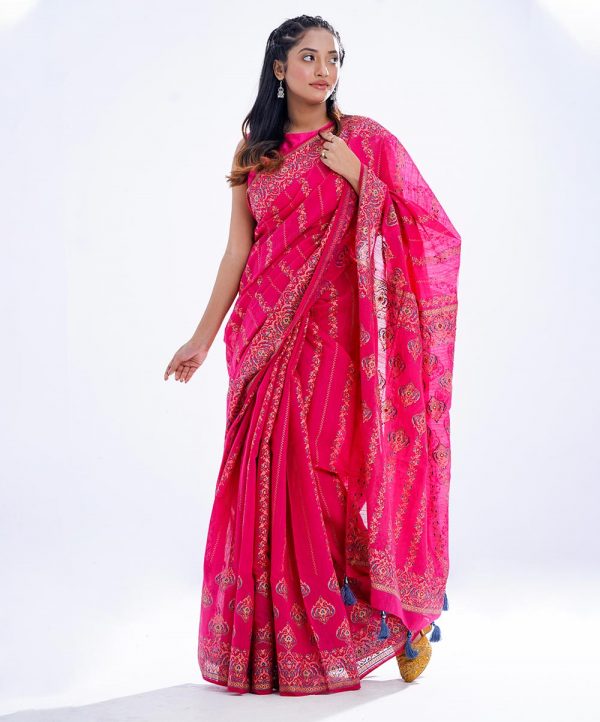 Pink all-over printed exclusive Saree in Half-silk fabric. Embellished with karchupi, and decorative tassels on the achal.