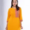 Yellow straight-cut kameez in Georgette fabric. Features a mandarin collar with hook closure at the front and three-quarter sleeves. Embellished with pin tucks at the front. Printed patch attachment at the cuffs and hemline. Unlined.