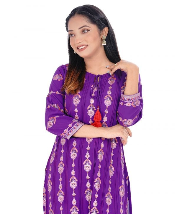 Purple all-over printed straight-cut kameez in Georgette fabric. Features a round neck with tasseled cords and three-quarter sleeves. Embellished with pin tucks and embroidery at the front. Patch attachment at the cuffs. Unlined.