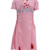 Pink A-line frock in Crepe fabric. Designed with a V-neck, puff sleeves and corset cords at the front. Embellished with flower print and embroidery at the top front. Single button opening at the back.