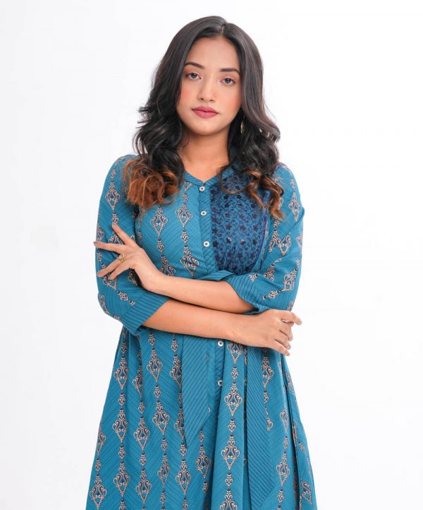 Turquoise Blue all-over printed A-line Tunic in Georgette fabric. Features a band neck with hook closure at the front, and three-quarter sleeves. Embroidered net attachment at the top front and pleats from the waistline. Tie-waist belts at the front. Detailed with swing stitches at the collar, placket, cuffs and belts.