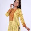 Yellow all-over printed straight-cut kameez in Viscose fabric. Features a round neck and three-quarter sleeves. Embellished with karchupi at the top front and cuffs.