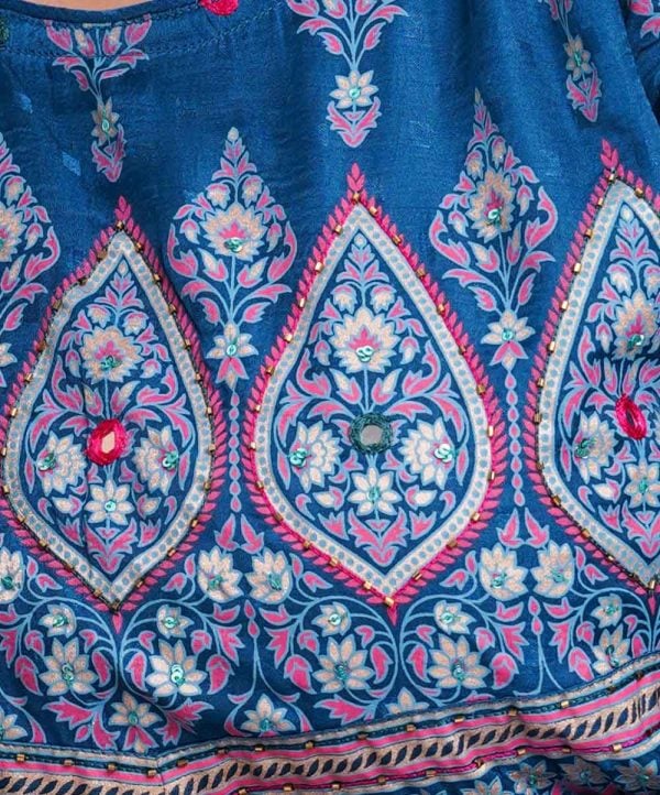 Blue all-over printed A-line Tunic in textured Silk-blend fabric. Designed with a round neck and three-quarter sleeves. Embellished with karchupi at the top front and cuffs. Viscose lining in half-body. Single button opening at the back.