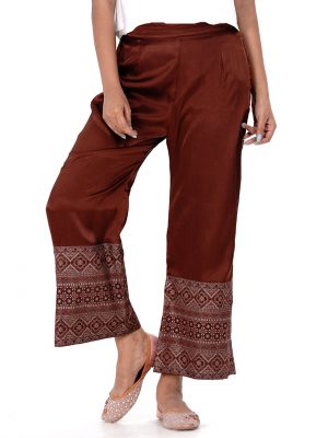 Chocolate Palazzo in Crepe fabric with prints on the border. Concealed elastication on the waistline.