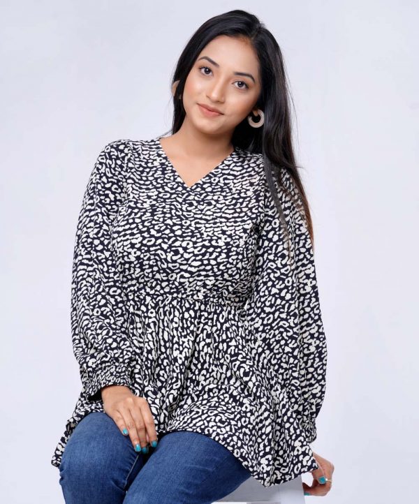 Black all-over printed retro wrap style Woven Top in Georgette fabric. Designed with a V neck and smoky puff Sleeves. Detailed with a Concealed elastication on the waistline.