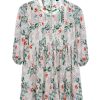 Off-white Tunic in printed Georgette fabric. Designed with a low mock neck and bishop sleeves. Detailed with pin tucks at the top front and gathers from the waistline. Lace attachment at the neck and hemline. Button opening at the back. Unlined.