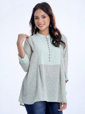 Mint A-line Tunic in printed Georgette fabric. Features a band collar with front button opening and roll-up sleeves. Designed with pleats at the front.