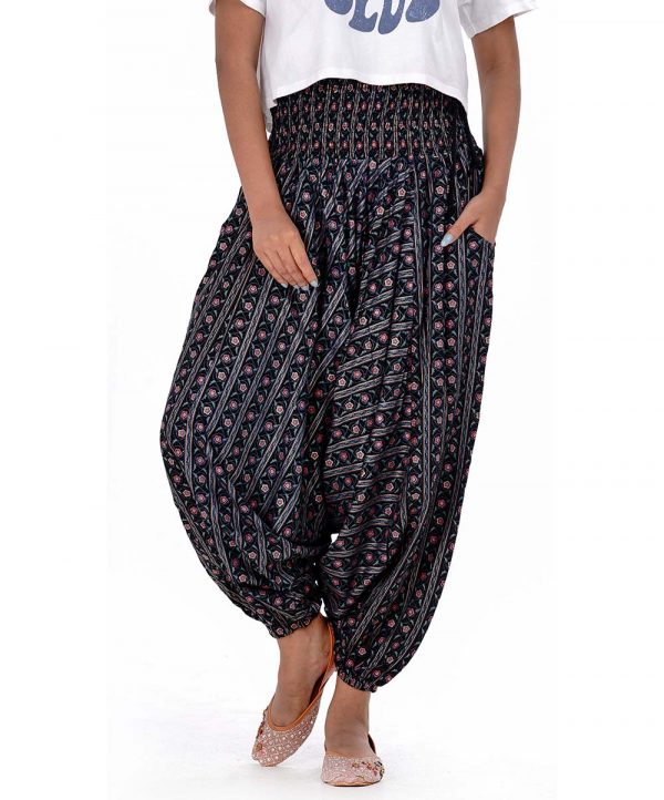 Black all-over printed Harem pants in Viscose fabric. Designed with smoked waistline with adjustable tasseled waist cords.