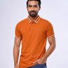 Orange Polo Shirt in Cotton pique fabric. Designed with a classic collar, short sleeves, and a metal logo attachment at the chest. Contrast tipping at collar and cuffs.