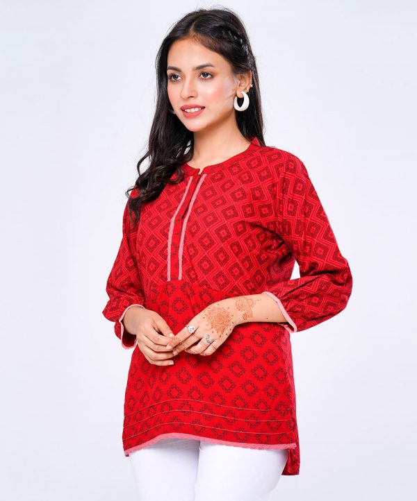 Red all-over printed straight-cut Tunic in Viscose fabric. Designed with a band neck and bishop sleeves. Embellished with pin tucks at the front.Features High-low hem. Lace attachment at the top front cuffs and hemline.