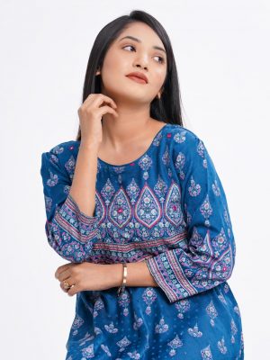Blue all-over printed A-line Tunic in textured Silk-blend fabric. Designed with a round neck and three-quarter sleeves. Embellished with karchupi at the top front and cuffs. Viscose lining in half-body. Single button opening at the back.