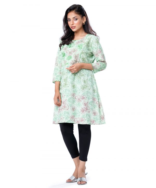 Green all-over printed A-line Tunic in Viscose fabric. Designed with a round neck and three-quarter sleeves. Embellished with embroidery at the front and cuffs. Gathers from the waistline. Single button opening at the back.
