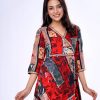 Red and Black all-over printed Retro-wrap style long Tunic in Georgette fabric. Designed with a V-neck and three-quarter sleeves. Printed patch attachment at the front and cuffs. Detailed with adjustable tasseled waist cords at the front.