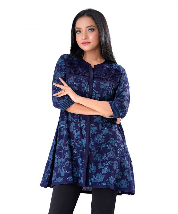 Blue all-over printed A-line ladies Shirt in Viscose fabric. Features a band neck with hook closure at the front and three-quarter sleeves. Designed with wave tucks at the top front. Swing stitches at the cuffs.