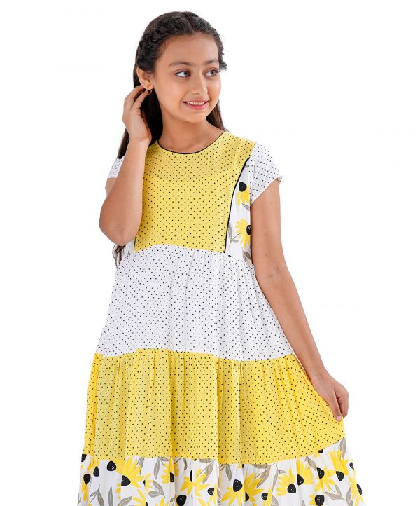 White and Yellow tiered pattern frock in Viscose fabric. Designed with a princess line cut and sew at the top front, cap sleeves and a round neck.