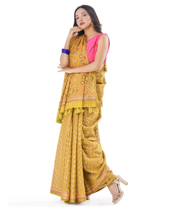 Olive Green all-over printed Cotton Saree with matching border. Embellished with decorative tassels on the achal.