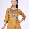 Mustard yellow all-over printed A-line Tunic in Viscose fabric. Designed with a boat neck and three-quarter sleeves. Embellished with karchupi at the front and gathers from the waistline. Single button opening at the back.