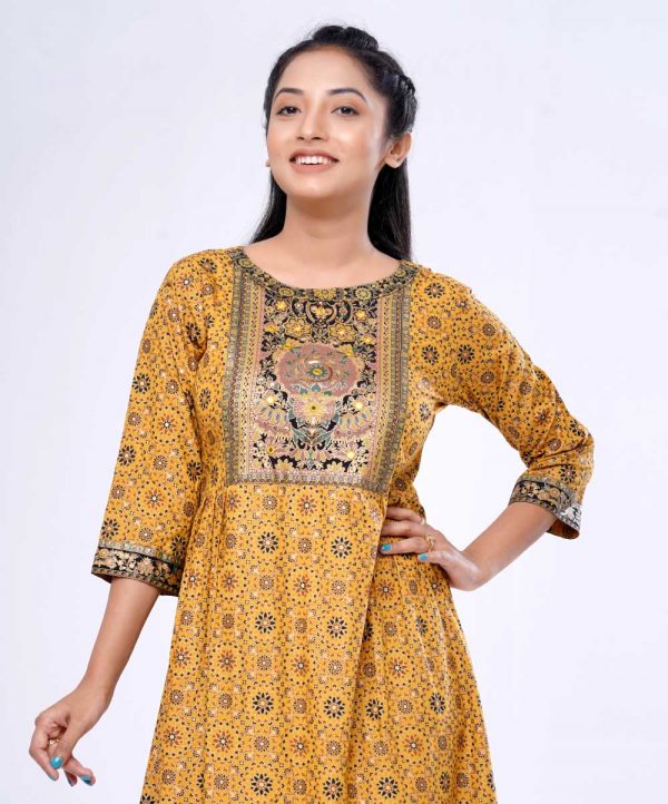 Mustard yellow all-over printed A-line Tunic in Viscose fabric. Designed with a boat neck and three-quarter sleeves. Embellished with karchupi at the front and gathers from the waistline. Single button opening at the back.