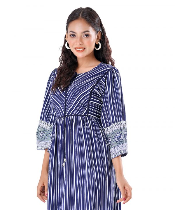Blue Tunic in printed Georgette fabric. Designed with a round tie-cord neck and three-quarter sleeves. Embellished with lace attachment at the front and gathers from the waistline. Unlined.