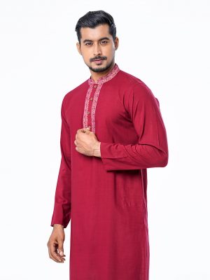 Red semi-fitted Panjabi in Slab Viscose fabric. Embellished with minimal karchupi on the collar and placket. Metal button opening on the chest.