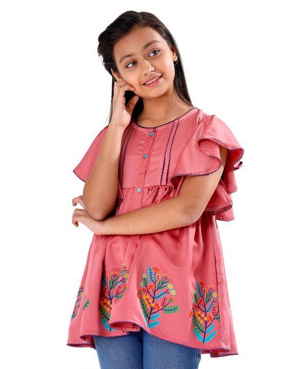 Peach Tunic in Georgette fabric. Features a round neck with button opening at the front and butterfly sleeves. Designed with beautiful print at the front and gathers from the waistline.