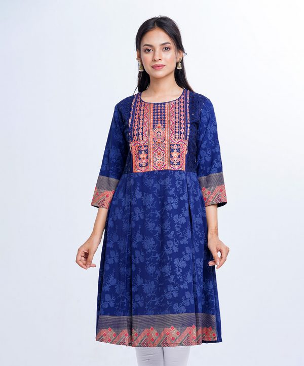Blue all-over printed A-line Tunic in Georgette fabric. Designed with a round neck and three-quarter sleeves. Embellished with embroidery and net attachment at the top front. Pleats from the waistline.