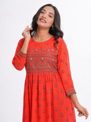 Orange all-over printed long Tunic in Georgette fabric. Designed with a round neck and three-quarter sleeves. Embellished with karchupi at the top front and gathers from the waistline.