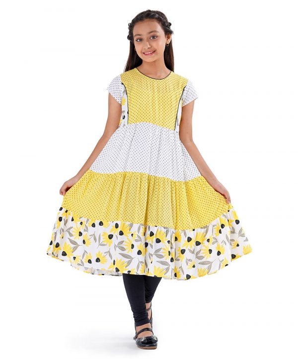 White and Yellow tiered pattern frock in Viscose fabric. Designed with a princess line cut and sew at the top front, cap sleeves and a round neck.