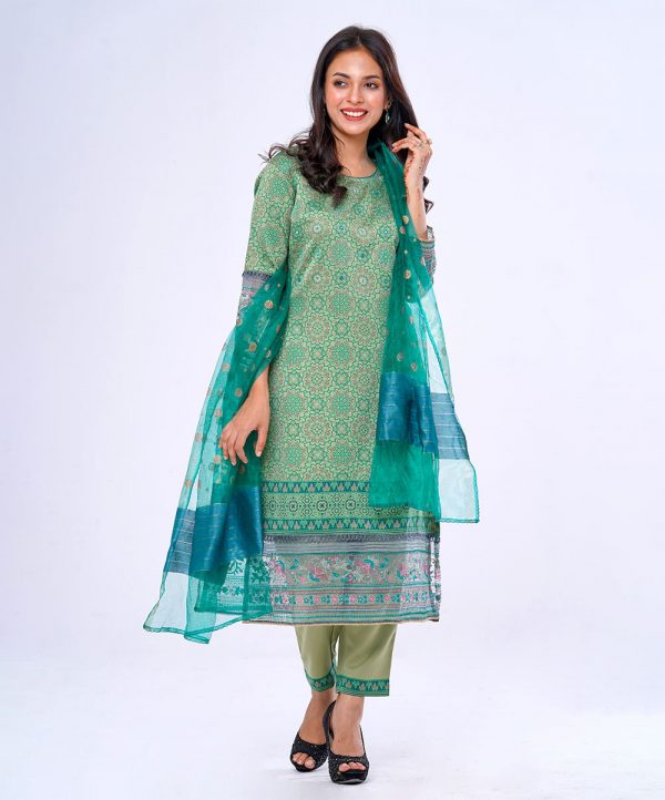 Green all-over printed Salwar Kameez in Crepe fabric. The Kameez is designed with a round neck and three-quarter sleeves. Embellished with embroidery at the top front. Detailed with decorative pin tucks, lace and embroidery organza attachment at the cuffs and hemline. Single button opening at the back. Complemented by culottes pants with printed border and half-silk dupatta.