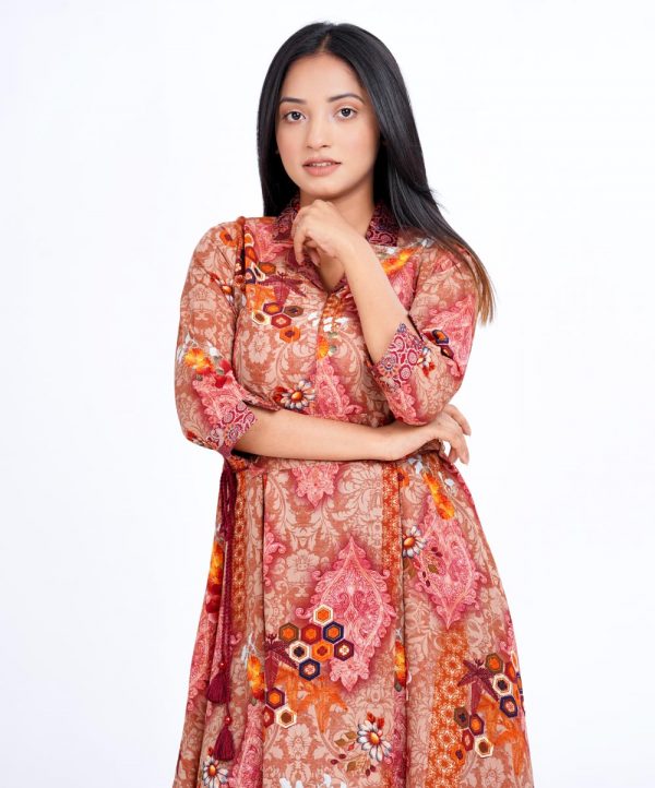Brown A-line Tunic in printed Georgette fabric. Features a lapel collar with hook closure at the front and three-quarter sleeves with cuffs. Detailed with pleats from the waistline. Tie-waist belt at the front. Unlined.