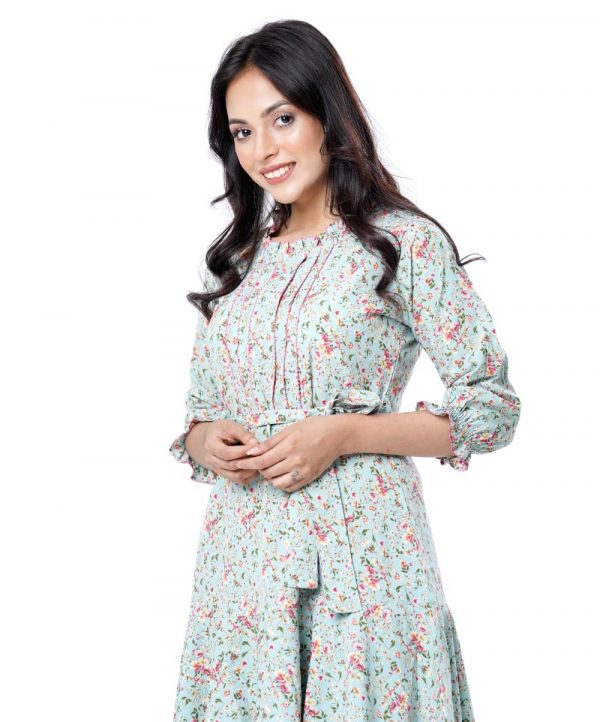 Mint Green all-over printed A-line Tunic in Georgette fabric. Designed with a frilled round neck and smoky puff sleeves. Embellished with pin tucks at the top front. Tie-waist belt at the front. Single button opening at the back. Unlined.
