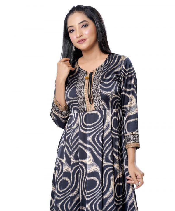 Black A-line long Tunic in printed Georgette fabric. Designed with a round tie-cord neck and three-quarter sleeves. Printed patch attachment at the top front, cuffs and hemline. Unlined.