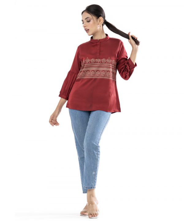 Maroon A-line Top in Crepe fabric. Designed with a band neck and lantern sleeves. Beautyful printed at the top front.