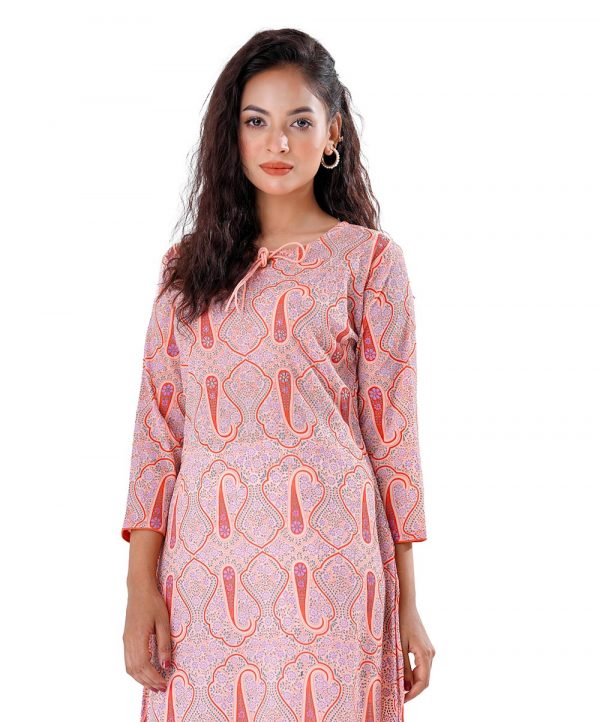 Peach all-over printed straight-cut Kameez in Georgette fabric. Features a round tie-cord neck and three-quarter sleeves. Designed with patch attachment at the hemline. Unlined.