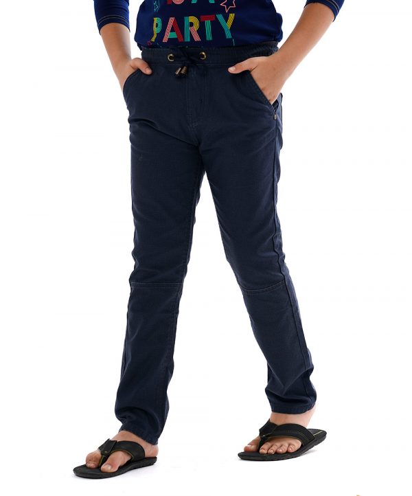 Blue woven pants in twill fabric. Five pockets, Covered elastic with adjustable drawstring at hemline & zipper fly.