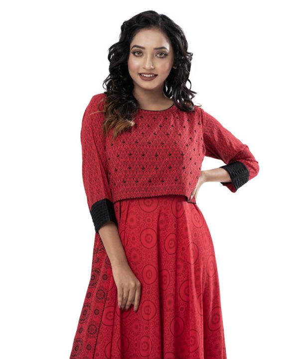 Red all-over printed layered Gown in Georgette fabric. Designed with a round neck and three-quarter sleeves with buttoned cuffs. Embellished with karchupi at the top front.