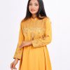 Yellow A-line Tunic in jacquard Georgette fabric. Designed with a high neck and full sleeves. Embellished with embroidery at the top front and cuffs. Elongated hemline. Button opening at the back.