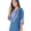 Blue all-over printed straight-cut Kameez in Crepe fabric. Designed with a round neck and three-quarter sleeves. Embellished with karchupi at the top front. Unlined.