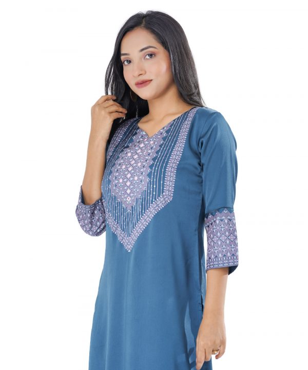 Blue all-over printed straight-cut Kameez in Crepe fabric. Designed with a round neck and three-quarter sleeves. Embellished with karchupi at the top front. Unlined.