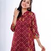 Marron all-over printed A-line Kameez in crepe fabric. Features a band neck with hook closure at the front and three-quarter sleeves. Designed with cut and sew at the front.