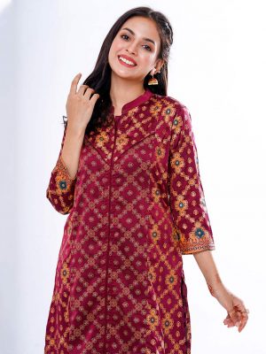 Marron all-over printed A-line Kameez in crepe fabric. Features a band neck with hook closure at the front and three-quarter sleeves. Designed with cut and sew at the front.