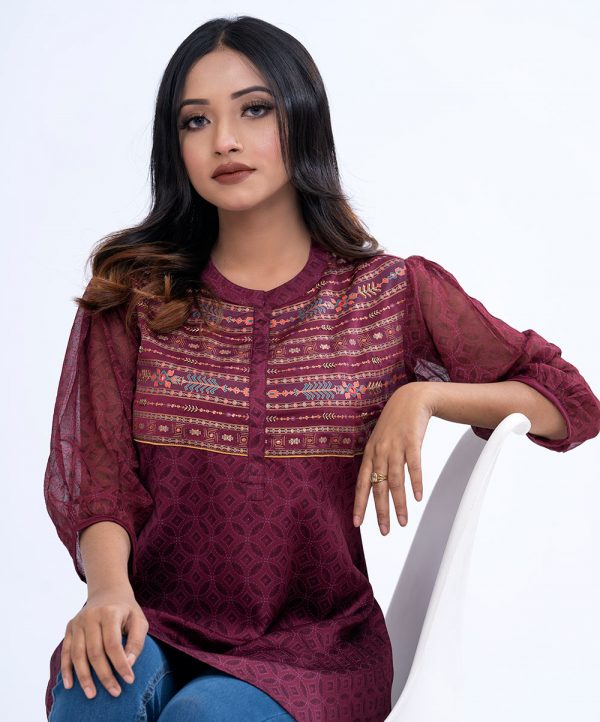 Maroon all-over printed A-line Top in Crepe fabric. Designed with a band neck and bishop sleeves. Embellished with karchupi at the top front.