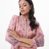 Pink all-over printed straight-cut Kameez in Crepe fabric. Features a band collar with hook closure at the front and three-quarter sleeves. Embellished with embroidery at the front and cuffs. Unlined.