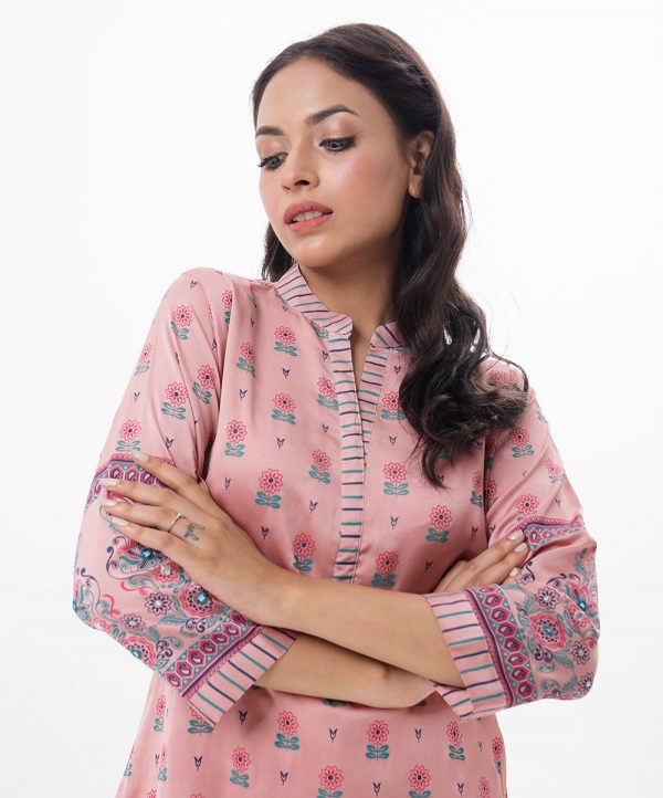 Pink all-over printed straight-cut Kameez in Crepe fabric. Features a band collar with hook closure at the front and three-quarter sleeves. Embellished with embroidery at the front and cuffs. Unlined.