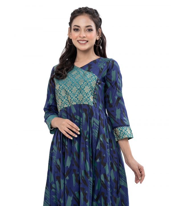Blue all-over printed retro-wrap style Tunic in Viscose fabric. Designed with a V-neck and three-quarter sleeves. Katan fabric detailing at the top front and cuffs. Stylized with pleats from the waistline.