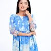 Sky blue tunic in printed Georgette fabric. Designed with a round neck and three-quarter sleeves. Smoked detailing at the top front. Gathers from the waistline.
