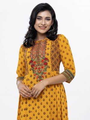 Yellow all-over printed A-line Tunic in Georgette fabric. Designed with a boat neck and three-quarter sleeves. Embellished with embroidery at the top front and pleats from the waistline. Single button opening at the back. Unlined.
